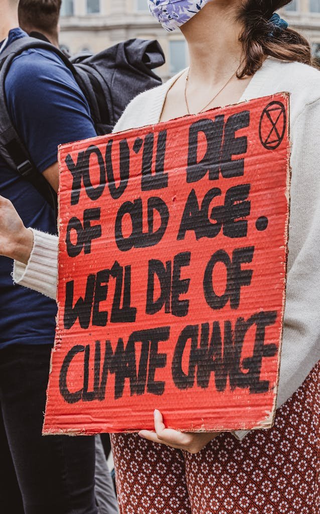 Protester holding a sign about climate change at a demonstration in London.